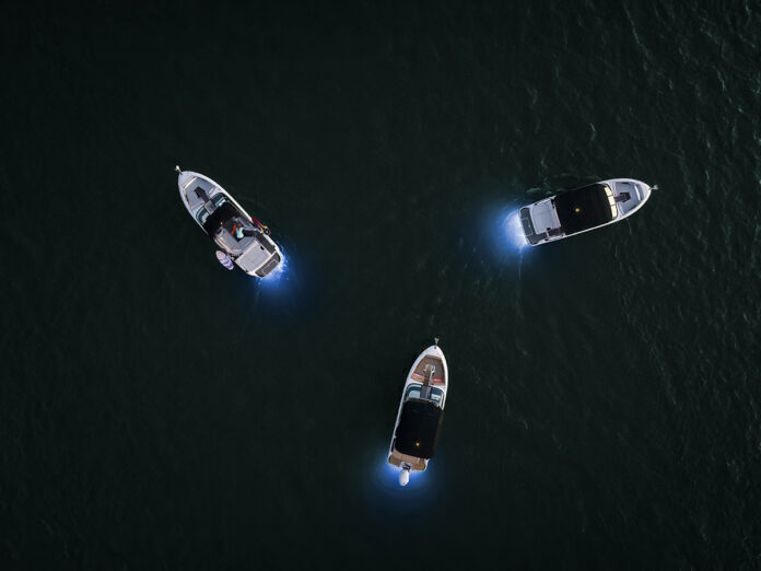 Aerial view of an SLX 260, SLX 260 Outboard and SLX 260 Surf at twilight