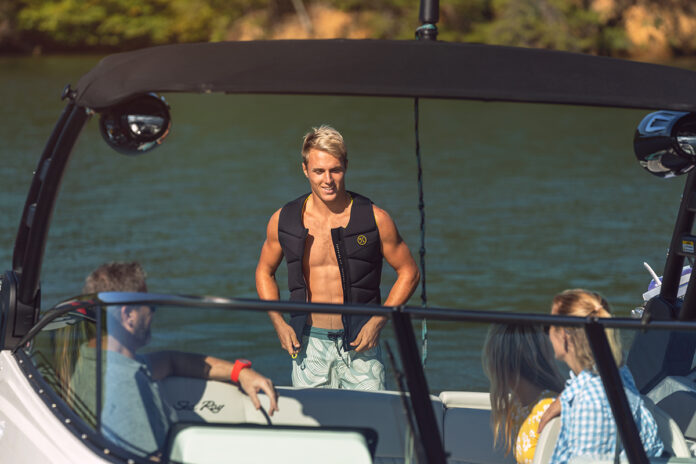 Man wearing a life jacket aboard an SLX 260 Surf