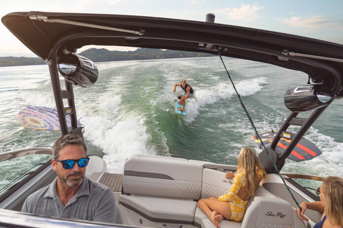 Man wakesurfing behind an SLX 260 Surf