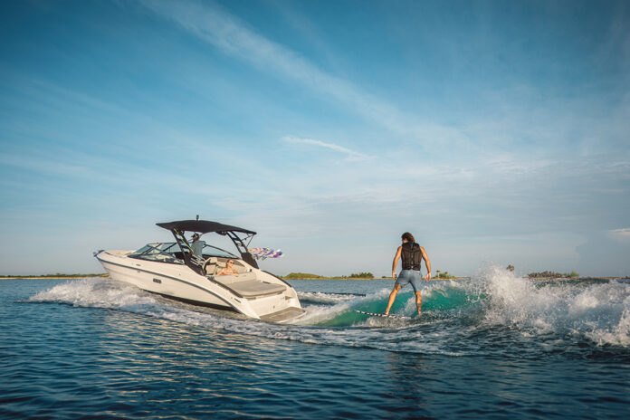 Man wakesurfing behind an SLX 260 Surf
