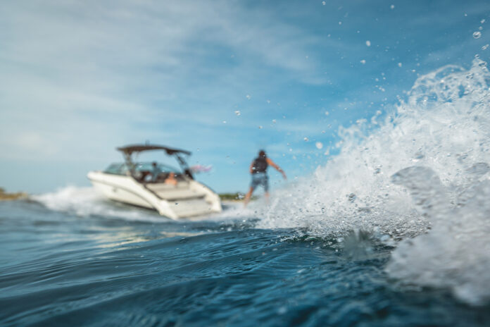Man wakesurfing behind an SLX 260 Surf