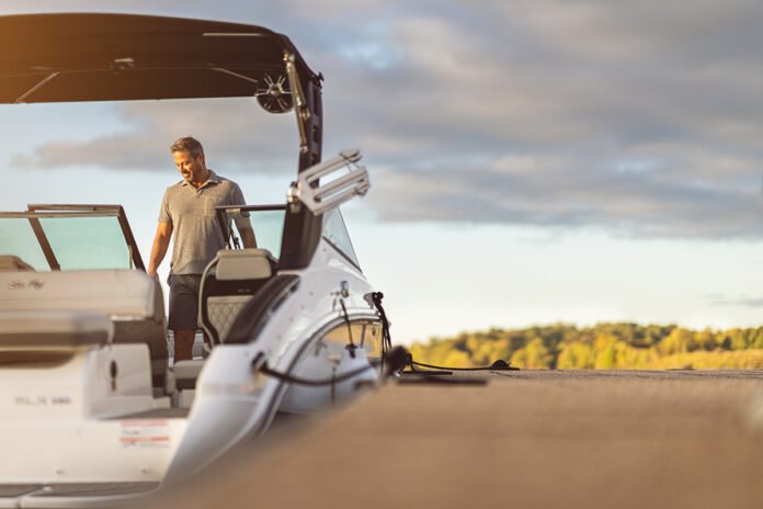 Man aboard a docked SLX 260 Surf