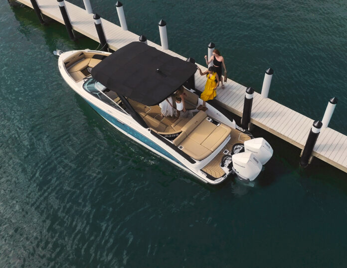 Aerial view of women boarding an SLX 280 Outboard from a dock