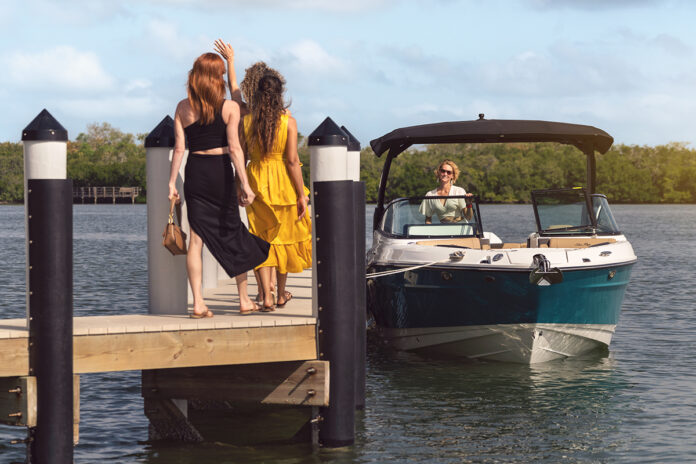 Women walking on a dock toward an SLX 280 Outboard