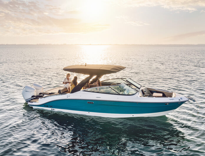 Women aboard an SLX 280 Outboard at sunset